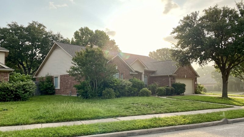 Pest Control Keller suburban Texas home with lush green lawn in humid summer climate where pests thrive